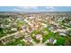 Wide aerial shot displaying a neighborhood with mature trees, manicured lawns, and a peaceful pond at 118 Presidential Ct, Greenfield, IN 46140