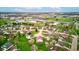 A high angle showing a residential area featuring well kept homes, green spaces, and a pond, under a partly cloudy sky at 118 Presidential Ct, Greenfield, IN 46140