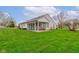 Expansive backyard with lush green grass and a charming screened-in porch attached to the house at 118 Presidential Ct, Greenfield, IN 46140