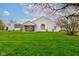Spacious backyard featuring green grass, mature trees, and a screened-in porch on the house at 118 Presidential Ct, Greenfield, IN 46140