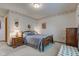 Traditional bedroom featuring a wood bed frame, carpet floors, and charming decor at 118 Presidential Ct, Greenfield, IN 46140
