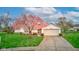 Charming single-story home with a well-manicured lawn and a beautiful flowering tree in the front yard at 118 Presidential Ct, Greenfield, IN 46140