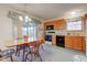 Well-lit kitchen with wooden cabinets, black appliances, and a view to the backyard at 118 Presidential Ct, Greenfield, IN 46140