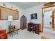 Comfortable office space with a beautiful desk, a filing cabinet, and an open door to the rest of the house at 118 Presidential Ct, Greenfield, IN 46140