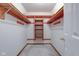 Empty walk-in closet with built-in wood shelving; perfect for organization and storage at 118 Presidential Ct, Greenfield, IN 46140
