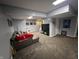 Spacious finished basement featuring a sectional couch, a TV, and neutral-toned walls and floors at 12458 Trumbull Ct, Fishers, IN 46038