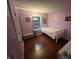 Bright bedroom featuring hardwood floors, a large window, and a cozy single bed at 12458 Trumbull Ct, Fishers, IN 46038