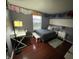 Cozy bedroom with dark wood floors, complemented by a white desk, and overhead decorations at 12458 Trumbull Ct, Fishers, IN 46038