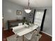 Dining room showcases a white table, modern chairs, and a decorative table runner at 12458 Trumbull Ct, Fishers, IN 46038