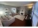 Comfortable living room with wood floors, a fireplace, and an area for a home office at 12458 Trumbull Ct, Fishers, IN 46038