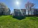 A sprawling backyard featuring a screened porch, set against neighboring homes at 12802 Ari Ln, Fishers, IN 46037