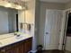 Bathroom featuring a double vanity, wood cabinets, and modern lighting at 12802 Ari Ln, Fishers, IN 46037