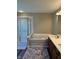 Bright bathroom featuring a bathtub, shower, and a dual sink vanity with modern finishes at 12802 Ari Ln, Fishers, IN 46037