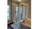 Bathroom featuring a walk-in shower and a large soaking tub at 12802 Ari Ln, Fishers, IN 46037