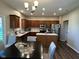 Stylish kitchen and dining area featuring wood cabinets, stainless steel appliances and a kitchen island at 12802 Ari Ln, Fishers, IN 46037