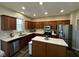 Bright kitchen features stainless steel appliances, wood cabinets, and granite countertops at 12802 Ari Ln, Fishers, IN 46037