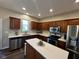 Bright kitchen with stainless steel appliances, wood cabinets, and granite countertops at 12802 Ari Ln, Fishers, IN 46037