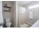 Neutral bathroom featuring a shower with curtain, open shelves and a toilet with a patterned tile floor at 14203 Cliffwood Pl, Fishers, IN 46038