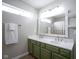 Bright bathroom features double sinks with modern faucets, a large mirror, and open shelving at 14203 Cliffwood Pl, Fishers, IN 46038