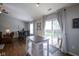 Dining area next to the kitchen features an island, sliding glass doors, wood floors, and contemporary décor at 14203 Cliffwood Pl, Fishers, IN 46038
