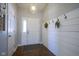 Bright entryway features wood floors, a coat closet, and stylish wall decor at 14203 Cliffwood Pl, Fishers, IN 46038