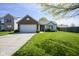 Charming one-story home features a manicured lawn and attached two-car garage at 14203 Cliffwood Pl, Fishers, IN 46038