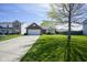 Charming one-story home features a manicured lawn and attached two-car garage at 14203 Cliffwood Pl, Fishers, IN 46038