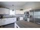 Charming kitchen features white cabinetry, sleek appliances, granite countertops, and an island with extra storage at 14203 Cliffwood Pl, Fishers, IN 46038