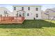 An ample backyard shows a sizable lawn and a wooden deck attached to the rear of the home at 14538 Baldwin Ln, Carmel, IN 46032