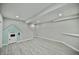 Spacious basement area with gray vinyl floors and bonus built-in playhouse at 14538 Baldwin Ln, Carmel, IN 46032