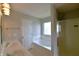 Clean bathroom featuring a double vanity, soaking tub, and glass-enclosed shower at 14538 Baldwin Ln, Carmel, IN 46032