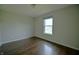 Neutral bedroom with laminate floors and a bright window view at 14538 Baldwin Ln, Carmel, IN 46032