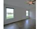 Bright bedroom with dark laminate floors and windows overlooking the yard at 14538 Baldwin Ln, Carmel, IN 46032
