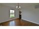 Dining room with hardwood floors, and view to kitchen at 14538 Baldwin Ln, Carmel, IN 46032