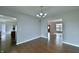 Dining room featuring hardwood floors and an open view to the kitchen and entry door at 14538 Baldwin Ln, Carmel, IN 46032