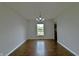 Dining room with hardwood floors and views to kitchen and backyard at 14538 Baldwin Ln, Carmel, IN 46032