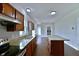 A view of the open kitchen with granite countertops, stainless steel appliances and dark wood cabinets at 14538 Baldwin Ln, Carmel, IN 46032