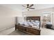 Bedroom with a wooden bed frame, ceiling fan, and windows for natural lighting at 14953 Lovely Dove Ln, Noblesville, IN 46060