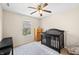 Sun-filled Bedroom with black crib, wood dresser, patterned rug, and ceiling fan at 14953 Lovely Dove Ln, Noblesville, IN 46060