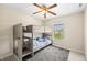 Bright bedroom features wood-look bunk beds with ladder and ceiling fan at 14953 Lovely Dove Ln, Noblesville, IN 46060