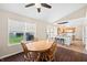 Cozy dining area with wood table set in front of large window and open to kitchen at 14953 Lovely Dove Ln, Noblesville, IN 46060
