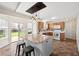 Well-lit kitchen featuring a large island, wood cabinets, stainless steel appliances, and a sliding door to the backyard at 14953 Lovely Dove Ln, Noblesville, IN 46060