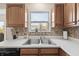 Kitchen area highlighting the sink, backsplash, window view, and stainless steel dishwasher at 14953 Lovely Dove Ln, Noblesville, IN 46060