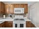 Kitchen featuring white appliances, wood cabinets, and countertops at 14953 Lovely Dove Ln, Noblesville, IN 46060