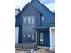 Modern two-story home showcasing a stylish blue exterior, black window frames, and brick accents at 16387 Burlwood Dr, Westfield, IN 46074