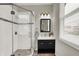 Modern bathroom boasting sleek vanity, tiled shower, and natural light from the window at 1826 N Alabama St, Indianapolis, IN 46202
