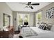 Bright bedroom featuring a ceiling fan, large windows, and a comfortable bed with decorative pillows at 1826 N Alabama St, Indianapolis, IN 46202