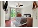Modern bedroom design with hardwood floors, a ceiling fan, and a stylish gray tufted bed at 1826 N Alabama St, Indianapolis, IN 46202