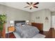 Serene bedroom with hardwood floors, neutral tones, a ceiling fan, and a cozy queen bed at 1826 N Alabama St, Indianapolis, IN 46202