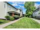 Charming home with a lush green lawn, inviting porch, and beautiful landscaping on a sunny day at 1826 N Alabama St, Indianapolis, IN 46202
